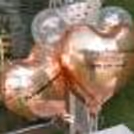 Two heart-shaped rose gold foil balloons with 1 promise on each.
