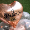 A heart-shaped Rose Gold Balloon saying "I Promise to" indicating to the 7 promises printed on other balloons.