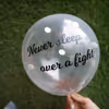 A helium confetti balloon with a 'never sleep over a fight' vinyl message.