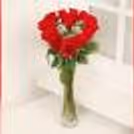 Romantic heart-shaped red rose decor in a glass vase, designed for Valentine's Day and anniversary celebrations.