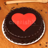 A chocolate flavoured cake with a heart on the top.