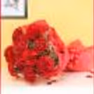 A bouquet of 10 red carnations wrapped in red paper.