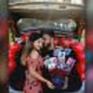 A loving couple with CherishX's Rose Bucket with photos.