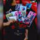Beautiful photos set up in the bucket with roses to give a wonderful look to the gift.