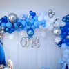 A balloon arc made up of chrome, metallic and pastel balloons in the shade of blue and white.