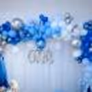 A balloon arc made up of chrome, metallic and pastel balloons in the shade of blue and white.