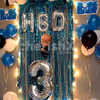 The Boss Baby Surprise Decor consists of 'HBD' Foil balloons as well as a Boss Baby cut-out for the wall.