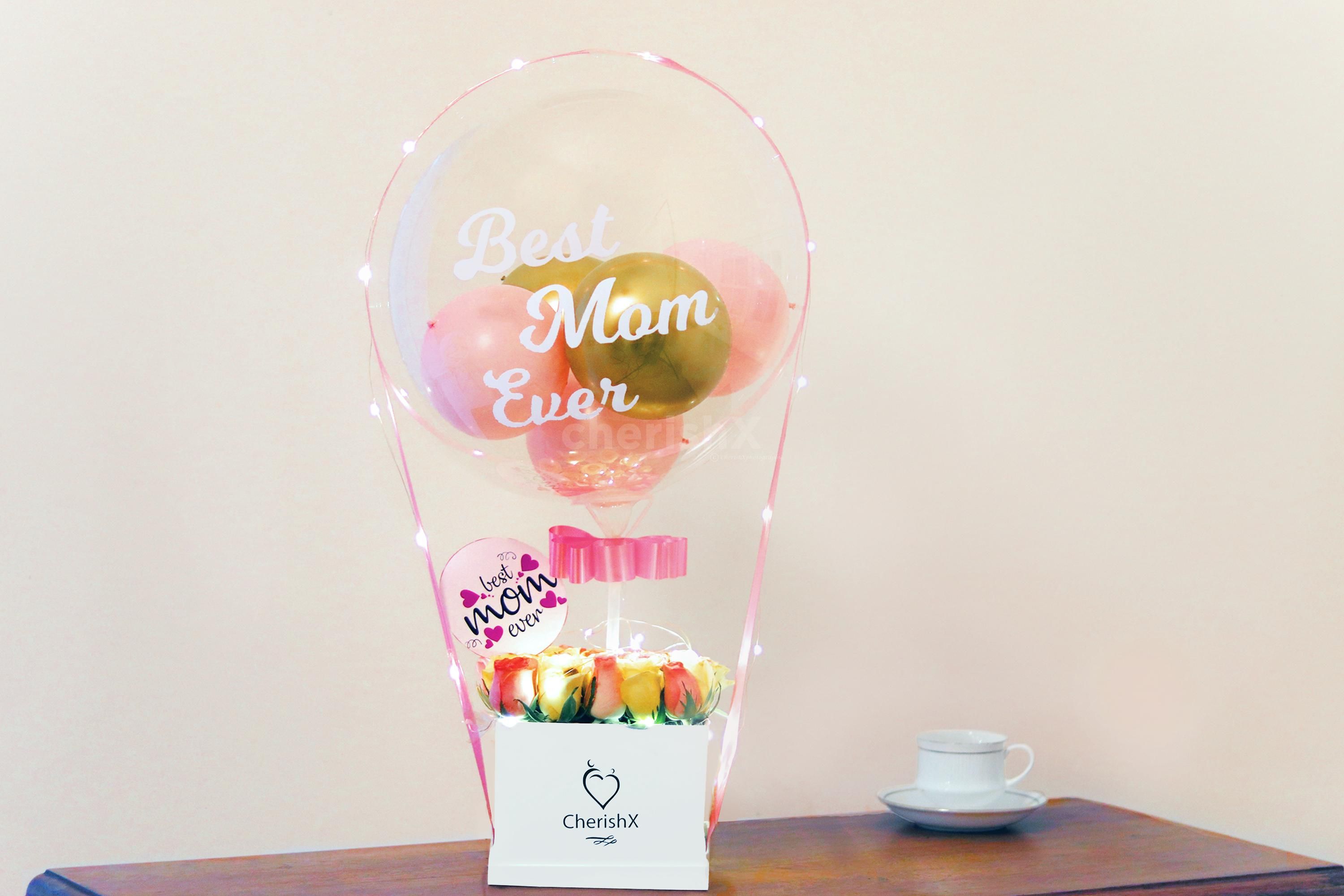 Gift this Mother's Day loving bucket filled with balloons and flowers to make the day special for your mother!