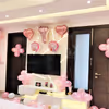 CherishX Welcome baby girl decor includes an arc of balloons at the entrance.