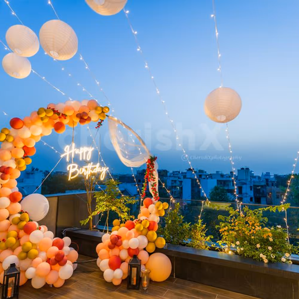 A terrace beautifully decorated with neon lights birthday decor .