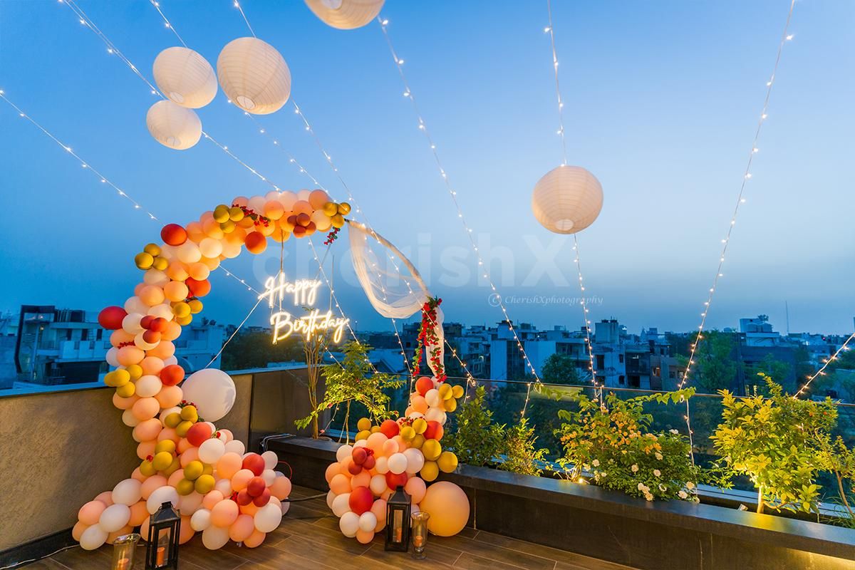 A terrace beautifully decorated with neon lights birthday decor .