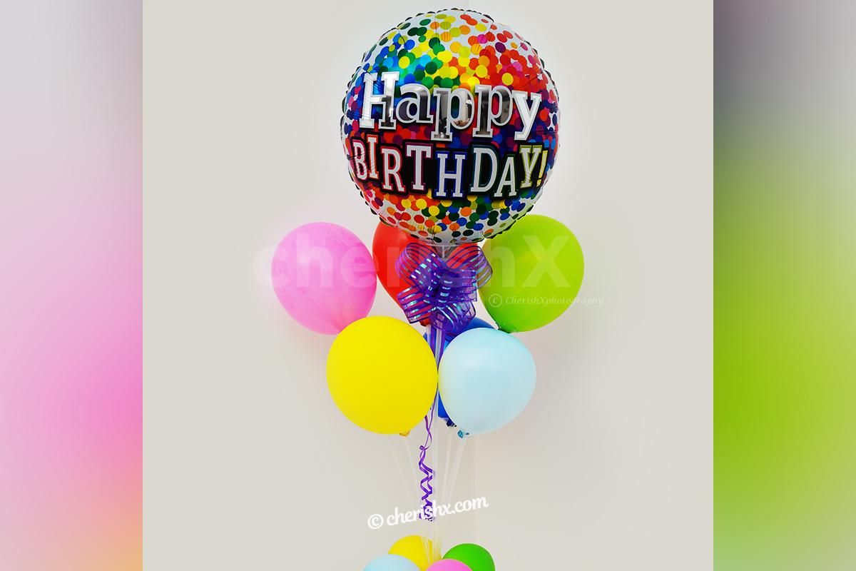 A birthday balloon Bunch stand with a purple ribbon for your party decorations