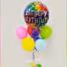 A birthday balloon Bunch stand with a purple ribbon for your party decorations