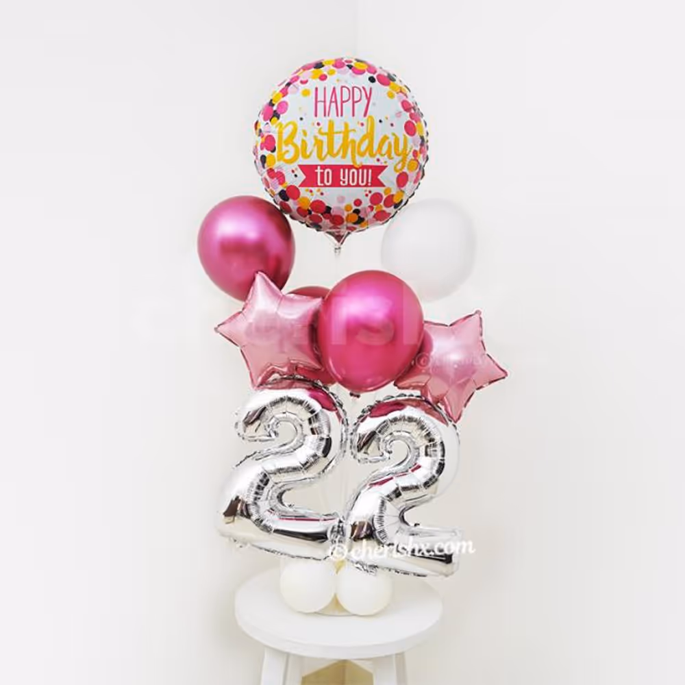 A Colourful Happy Birthday Foil Balloon placed at the top of the balloon stand.