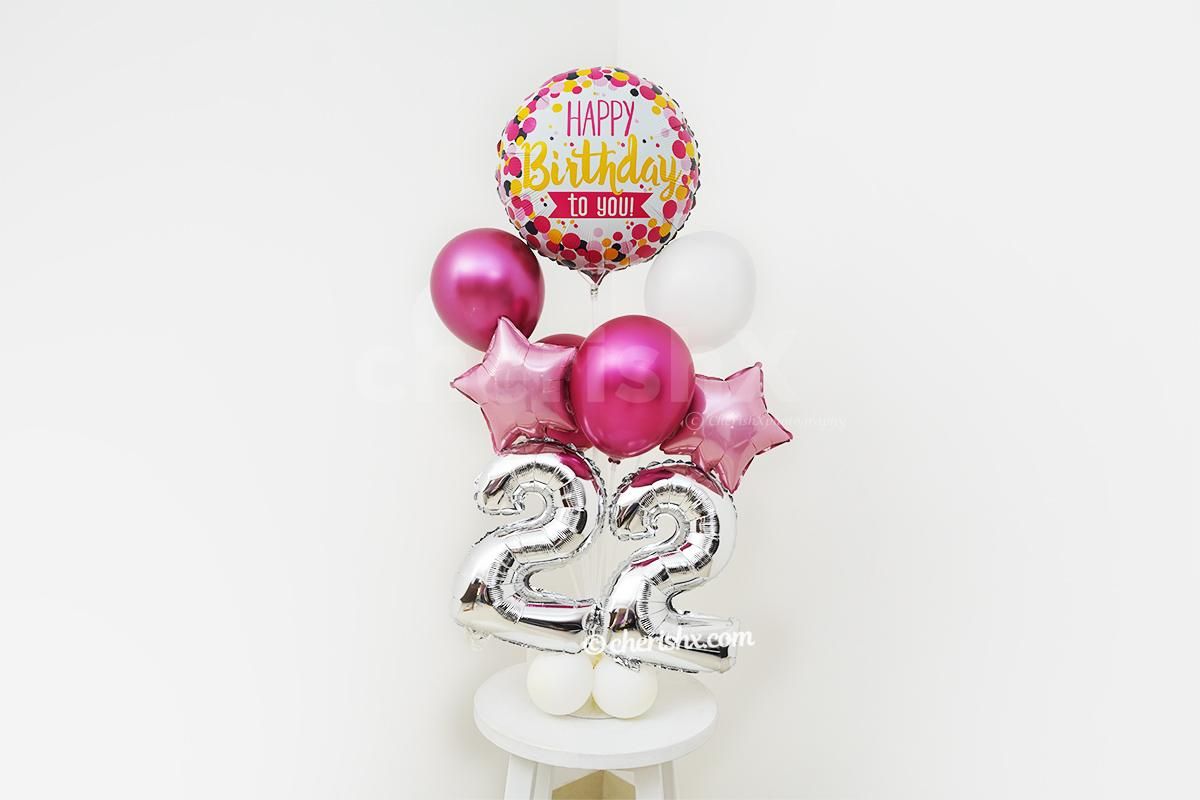 A Colourful Happy Birthday Foil Balloon placed at the top of the balloon stand.