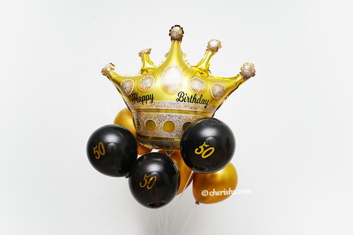 A Gold crown balloon placed at the top of the birthday balloon bunch.
