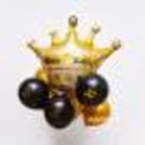 A Gold crown balloon placed at the top of the birthday balloon bunch.