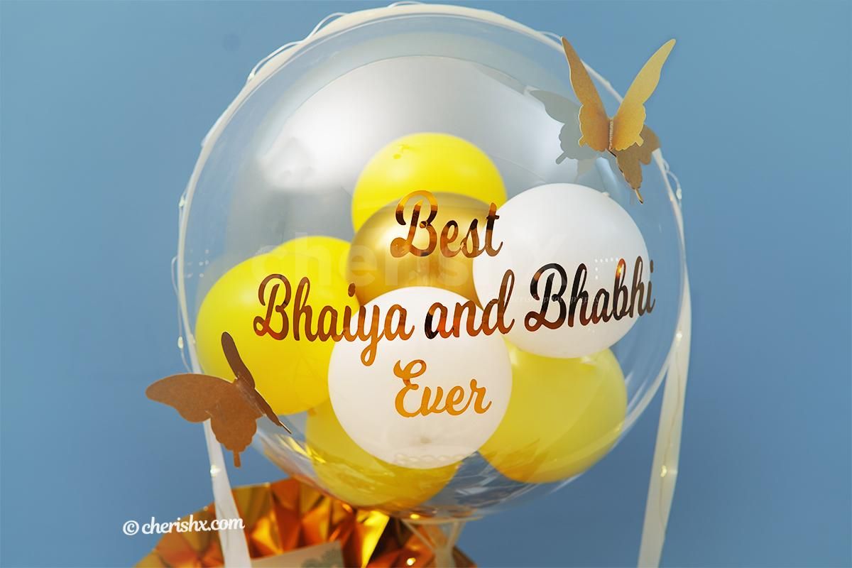 CherishX's yellow and gold Rakhi bucket consists of pictures, chocolates, and rosette for a better experience.