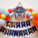 Silver star shaped foil balloon with PAW Patrol Badge Sticker on it.