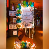 Theme based Welcome Board (3x2ft) with Easel Stand decorated with a balloon arch.