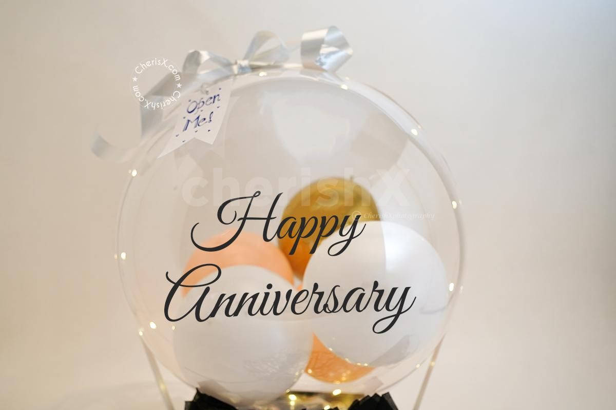 A Bubble Balloon with Golden Chrome, White Latex and Pastel Peach balloon inside.