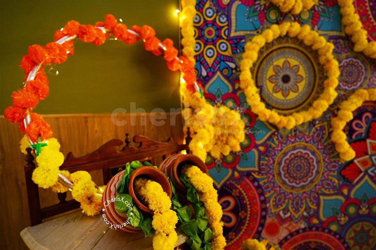A Round Photo Selfie Frame Decorated with Flower Garlands and a battery-operated Light.
