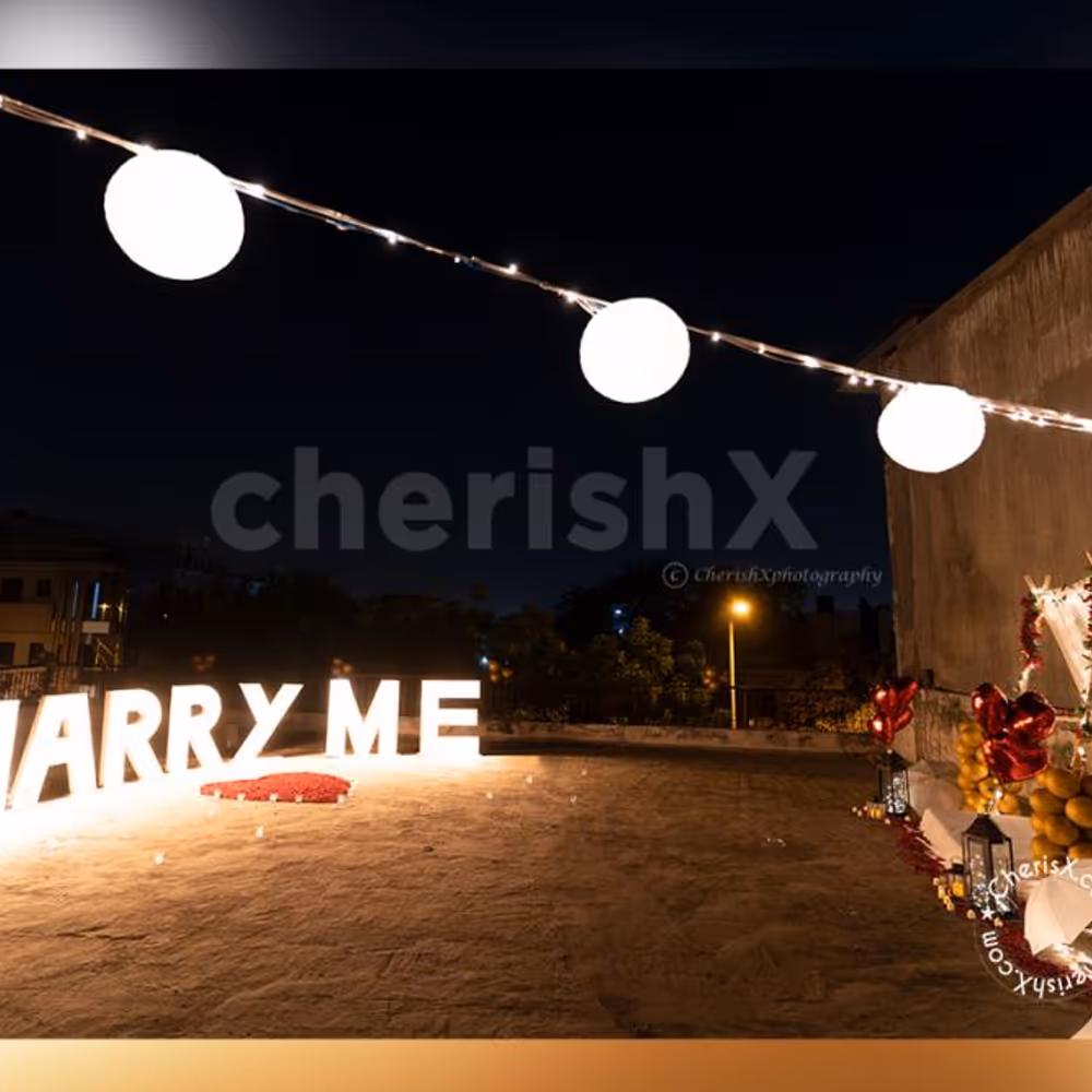 Grand Marry Me Led Letters places with heart made with red rose petals.