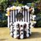 The Black and Golden Decor includes this table decorated with White Latex and Black Latex balloons placed with Black and white strips backdrop.