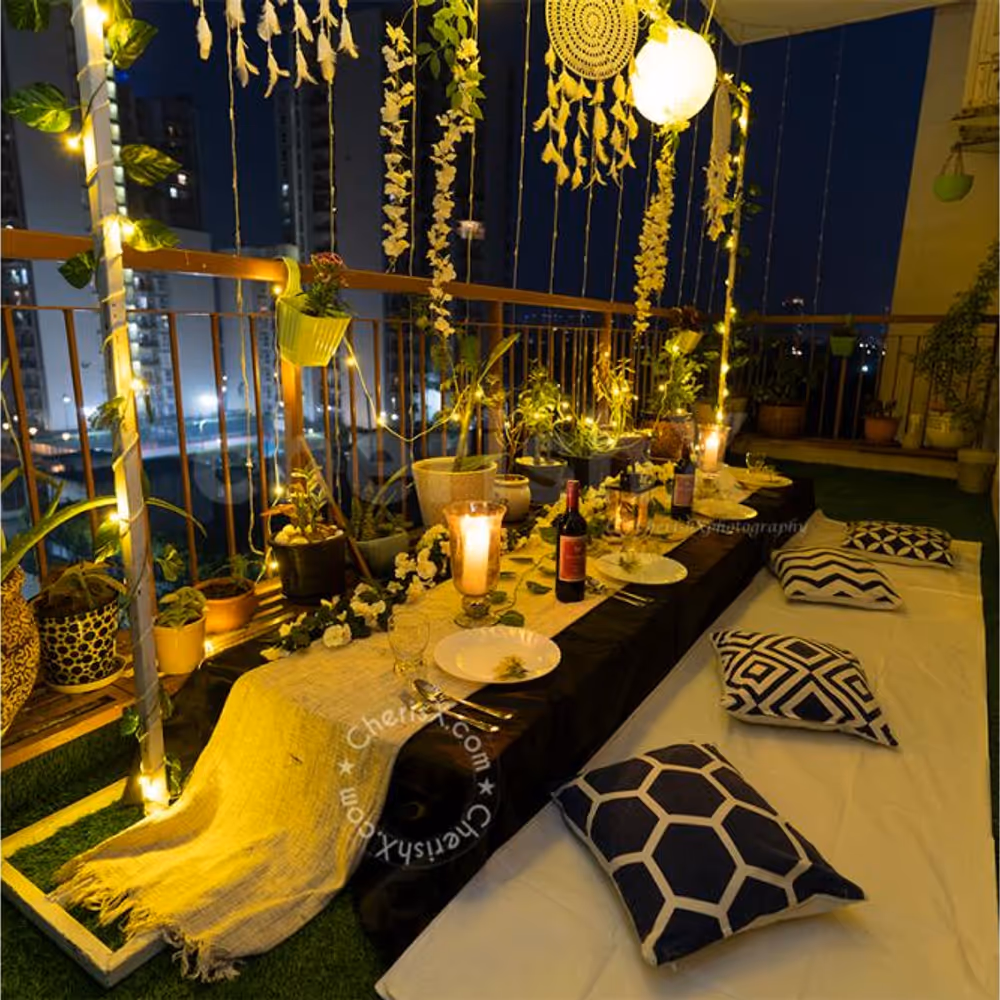 Low Dining Tables decorated with 2 Golden Vase filled with White Flower Bunches and a Golden Lamp placed on the table for the Boho Dining Experience.