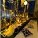 Low Dining Tables decorated with 2 Golden Vase filled with White Flower Bunches and a Golden Lamp placed on the table for the Boho Dining Experience.
