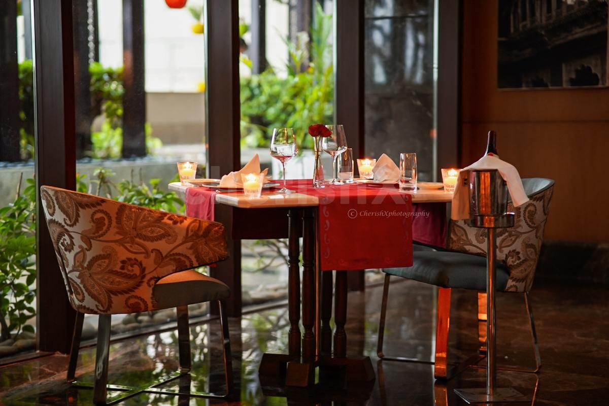 A relaxing evening at Dilli 32 with a brilliant indoor date set up of flowers, candles, meals, and more