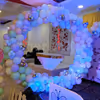 Modern elements of paper cuts, balloon arch, and sun board cutouts for an enhanced birthday experience