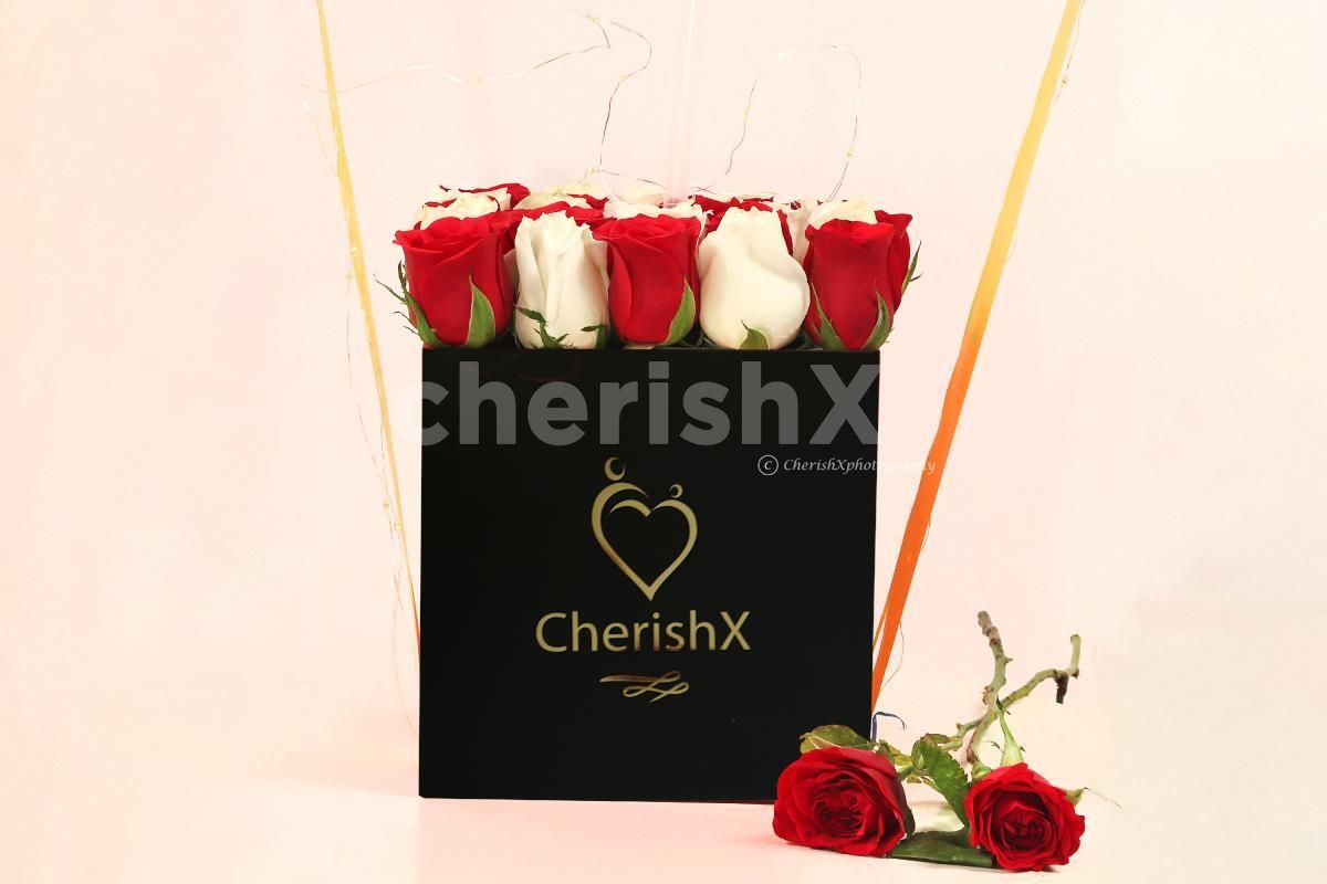 A heart-warming balloon bucket filled with white and red roses!