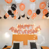 The text engraved in rose gold foil with black white and rose gold balloons hanging from the ceiling just lights up the ambience