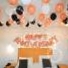 The text engraved in rose gold foil with black white and rose gold balloons hanging from the ceiling just lights up the ambience