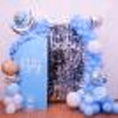 It's a Boy shimmer backdrop decoration with elegant blue balloon styling