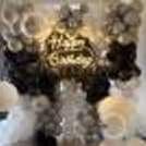 Black and silver theme balloon wall decoration for a stylish party celebration