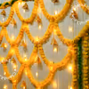 A mix of yellow and green garland around the wall will set the perfect pooja atmosphere