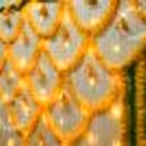 A mix of yellow and green garland around the wall will set the perfect pooja atmosphere