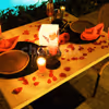 The candles and rose petals added to your poolside table adds love to the air
