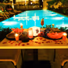 The candles and rose petals added to your poolside table adds love to the air