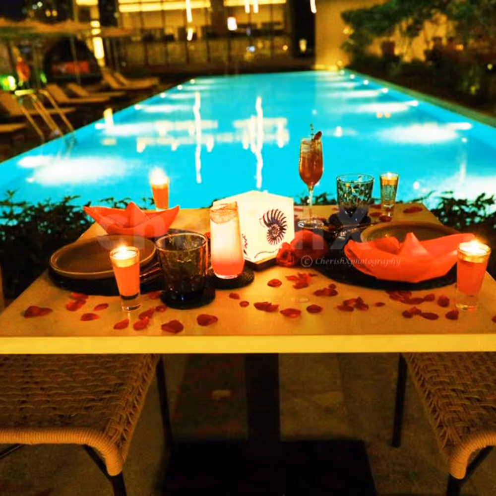 The candles and rose petals added to your poolside table adds love to the air