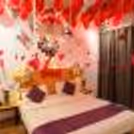 The red roses and balloons make the night romantic