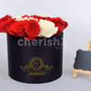 A bucket, full of red roses in which the letter is highlighted with white roses.