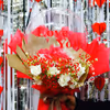 This unique bouquet combines classic red roses with cheerful balloons
