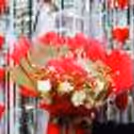 This unique bouquet combines classic red roses with cheerful balloons