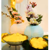 The yellow flower garlands in a rectangle stand are a contrastingly beautiful Mehndi backdrop setup