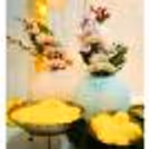 The yellow flower garlands in a rectangle stand are a contrastingly beautiful Mehndi backdrop setup
