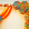 Placing umbrellas on the walls are attractive centrepieces for your mehndi or haldi celebration.