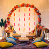 The brass lamps and pots filled with flowers make the Haldi event provide a traditional outlook
